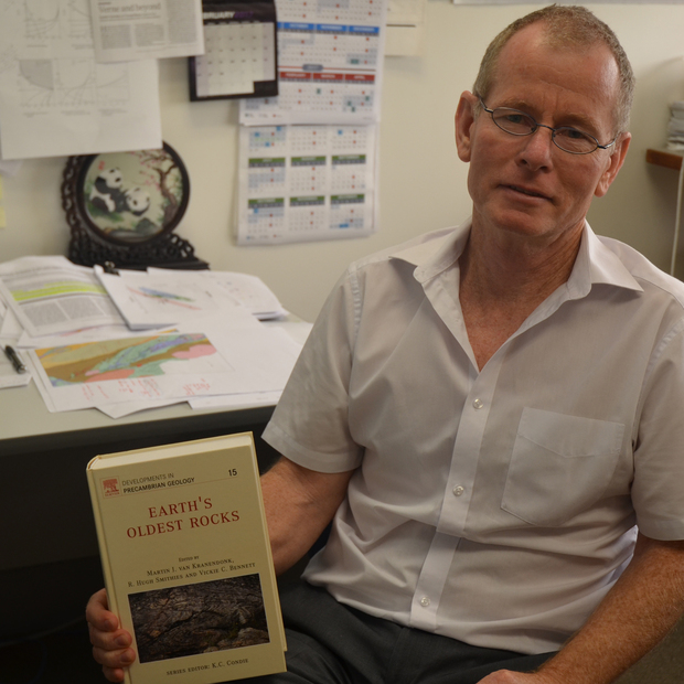 Dr Hugh Smithies with a copy of the Earth’s Oldest Rocks, first published in 2007, a book he  edited with former GSWA geologist Professor Martin Van Kranendonk.