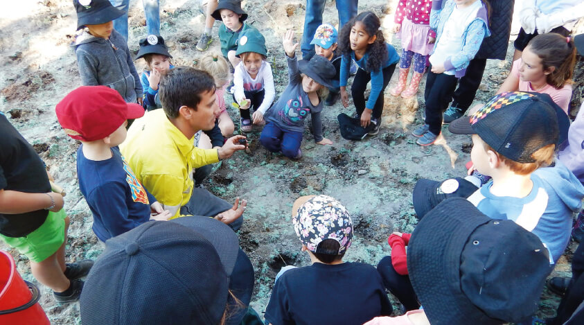 Allanson Primary School students plant trees as part of the revegetation works at the Black Diamond site.