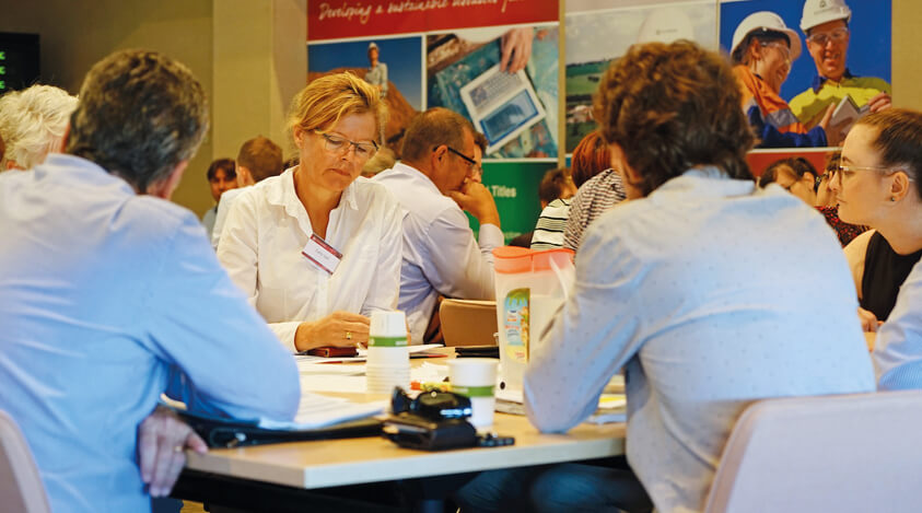 Participants at a Mining Proposal Implementation Workshop discuss key aspects of the new guideline.